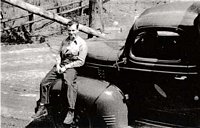 This unidentified CCC member of Camp Kanawha enjoys a moment of relaxation. Note the clean, shining condition of the vehicle. The boys not only stayed busy working during the regular day, but they also worked back at camp keeping the vehicles looking their best.