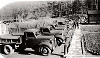 Some Camp Kanawha CCC trucks. Every CCC company was mobilized to carry out its varied conservation missions. Frequently, the boys had to travel far from camp each day to road-building and erosion control sites. These field crews were divided into work detail sections. This photo was probably taken on a weekend.