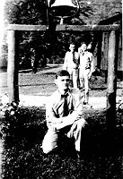 V.E. Bolyard, enrollee of Camp Parsons pictured in 1940 near the camp entrance. It seems most, if not all CCC camps had bells for routine calls and emergencies. Ibid, page 64.